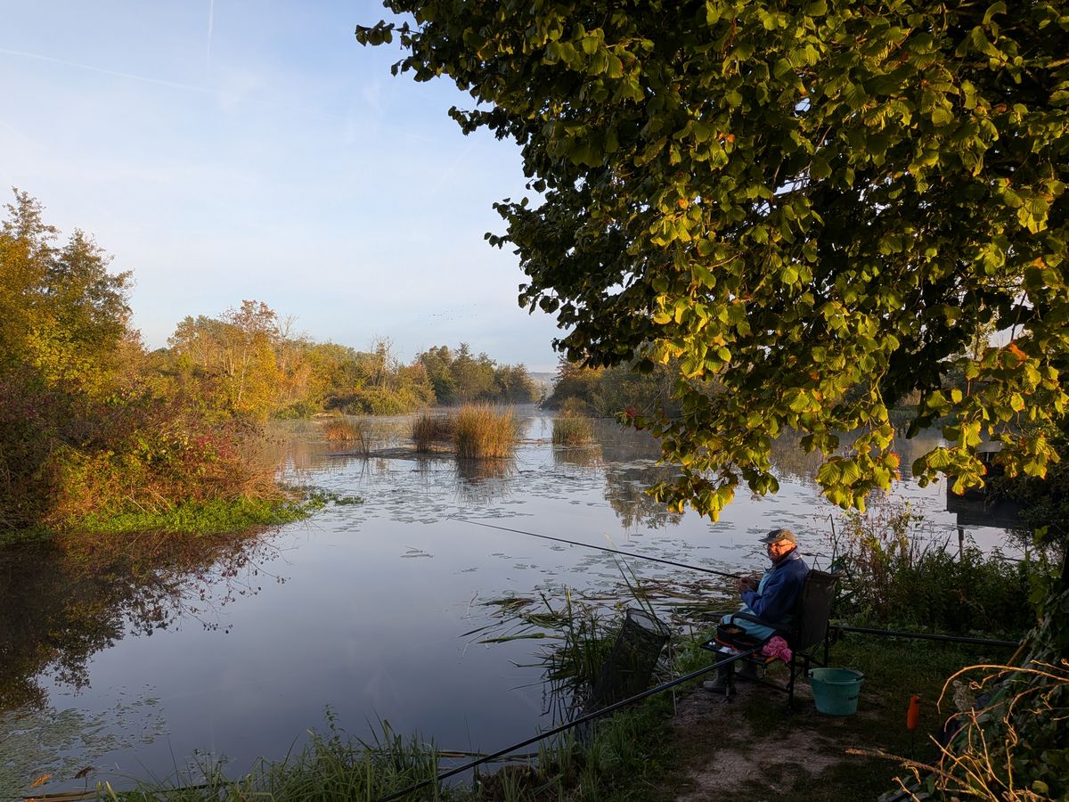 Angler with a rod by the pond
