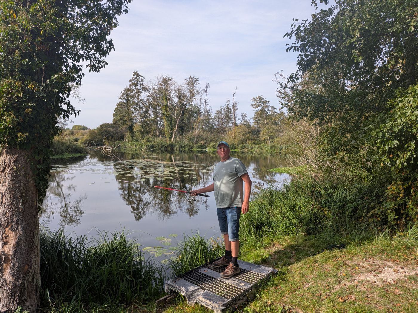 Angler on a platform at the water's edge