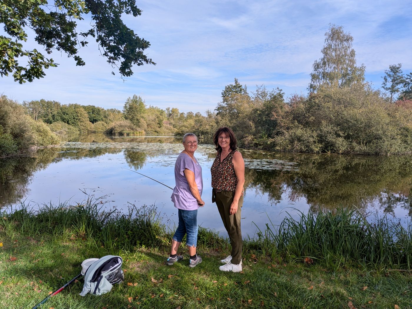Two friends fishing by the pond